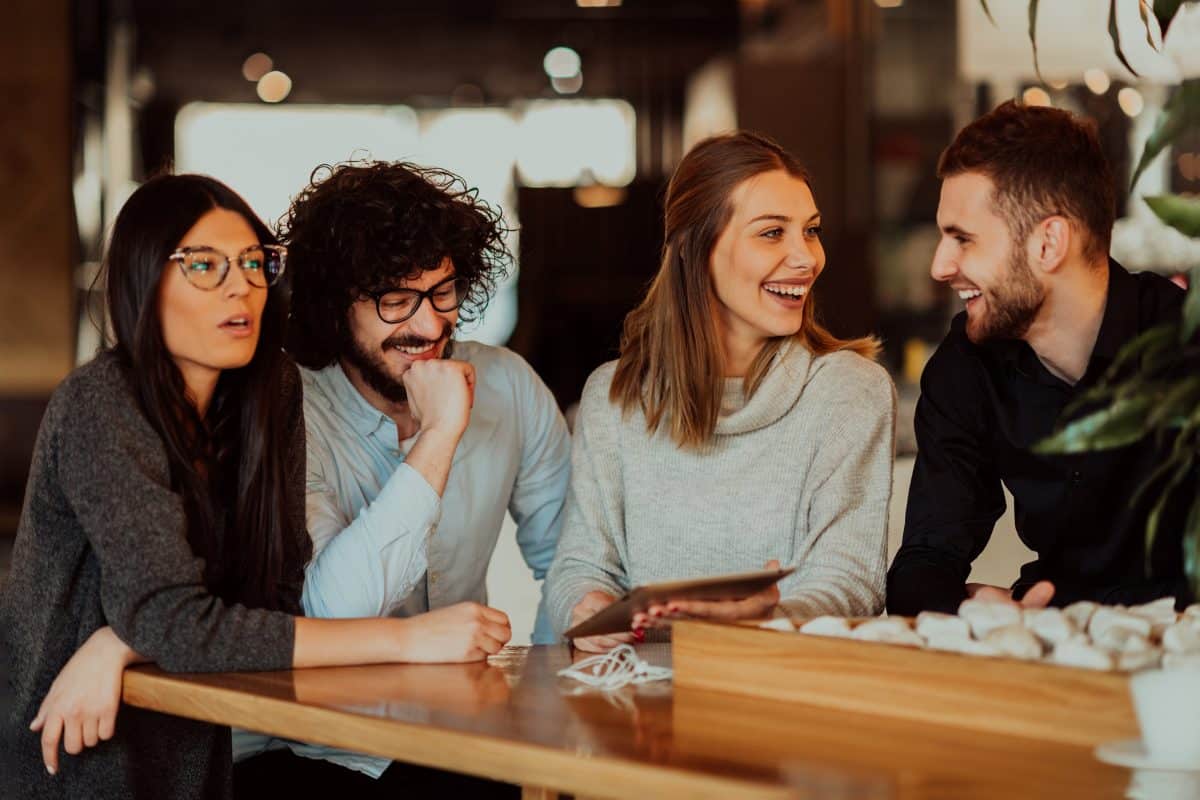 roup of friends hanging out in a cafe, and talking about business