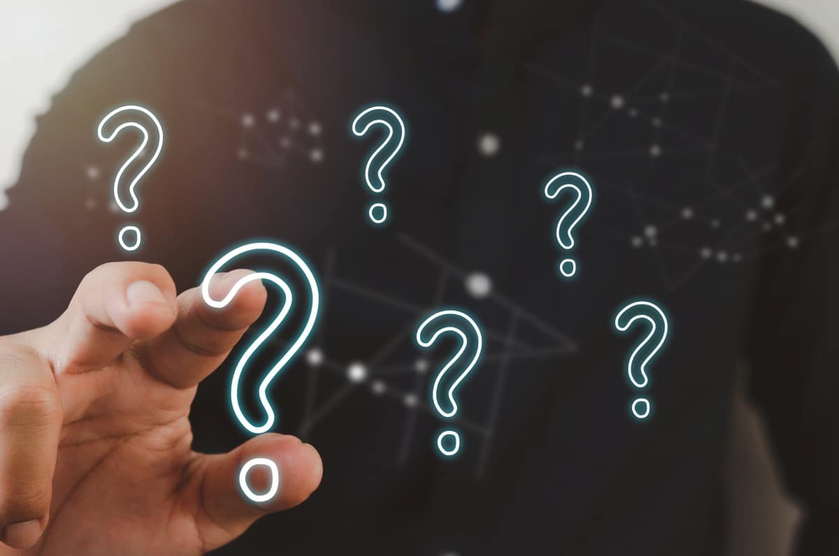 man pointing a question mark