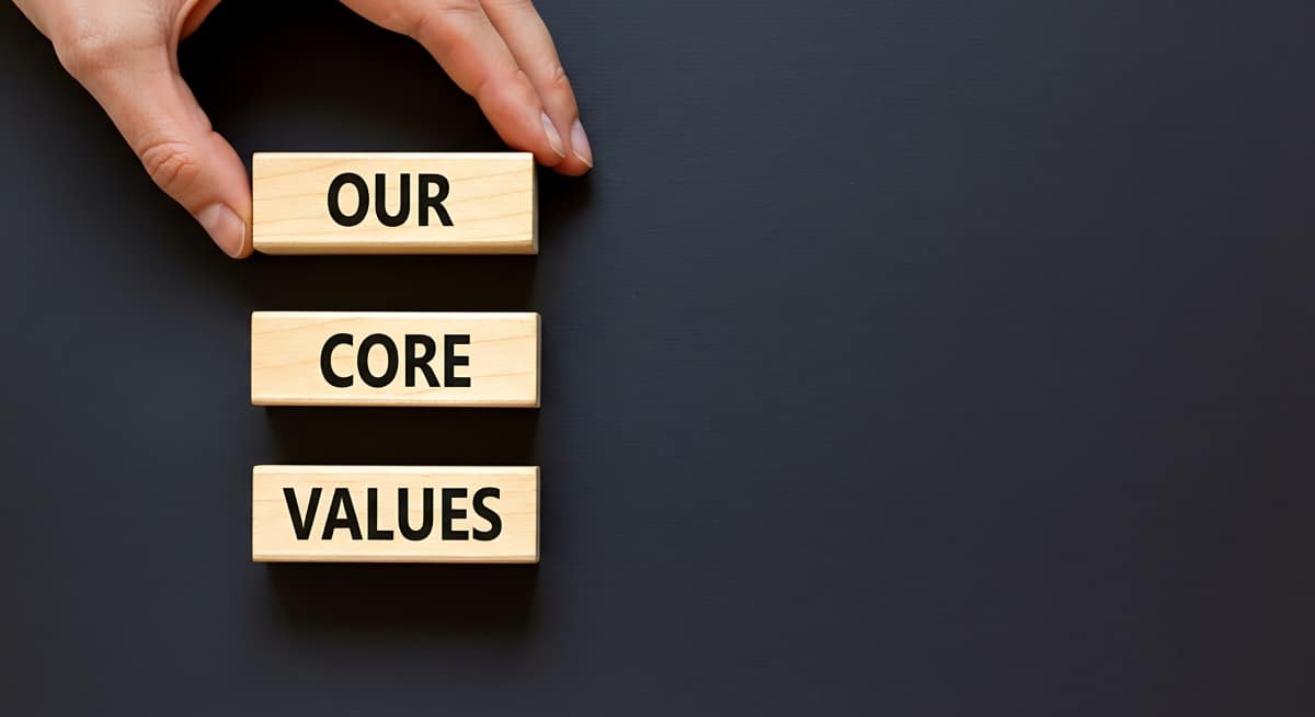 words our core values printed on small wooden blocks on black background