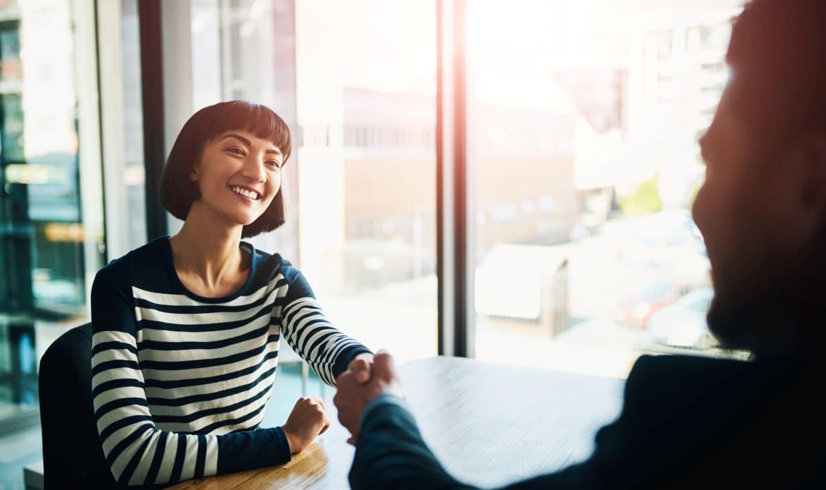 Shaking hands, agreement and business woman in office for b2b partnership, deal or recruitment