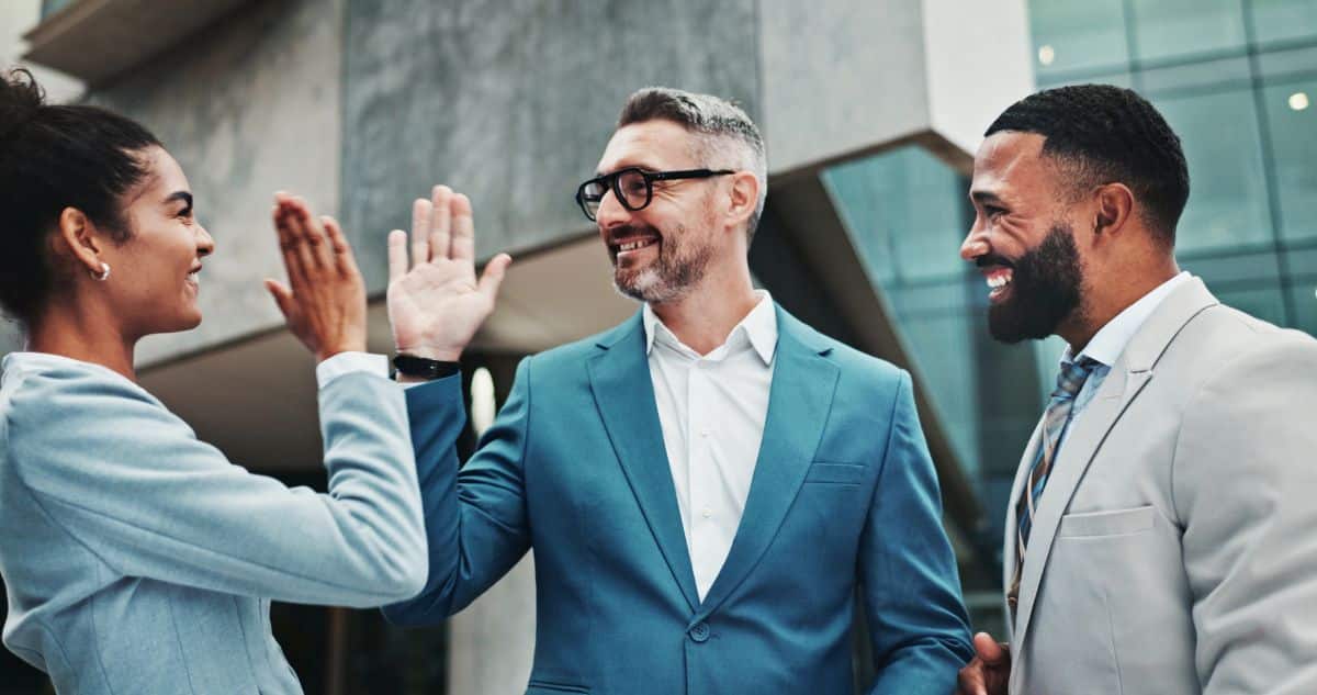 People, happy or high five in city for business, achievement or investment win for urban development