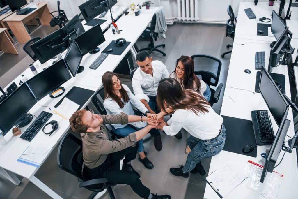 People talking and working together in the modern office near computers