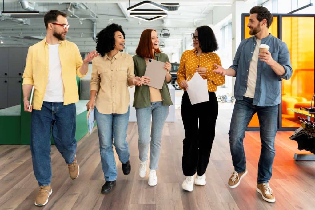 Group of diverse business people walking and talking in modern office